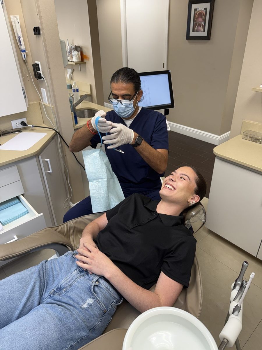 Dr. Patel preparing to treat a patient at The Smile Gallery in Melbourne, FL