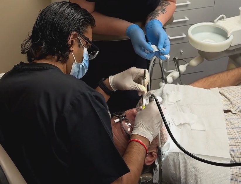 Dr. Patel treating a patient at The Smile Gallery in Melbourne, FL